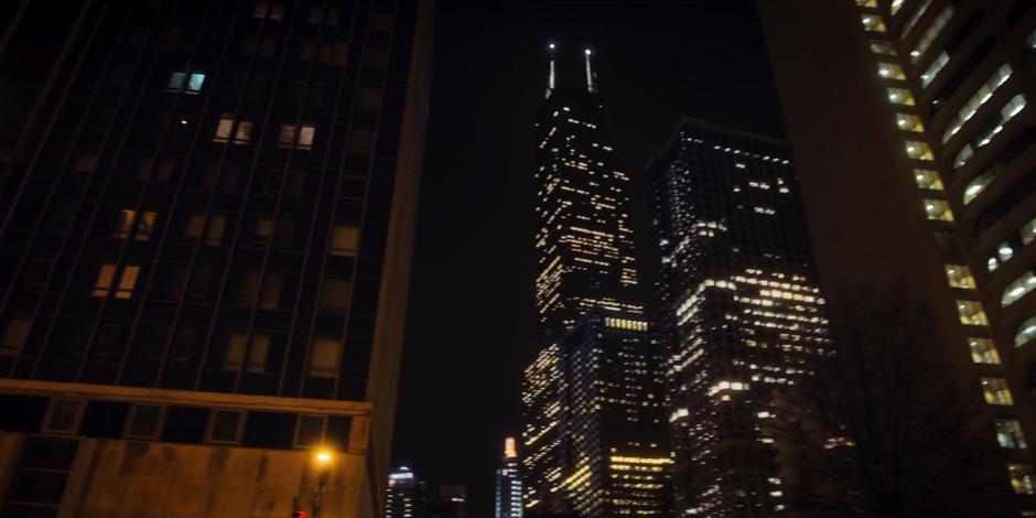 Eleven looks up at the Sears Tower and the other big buildings.