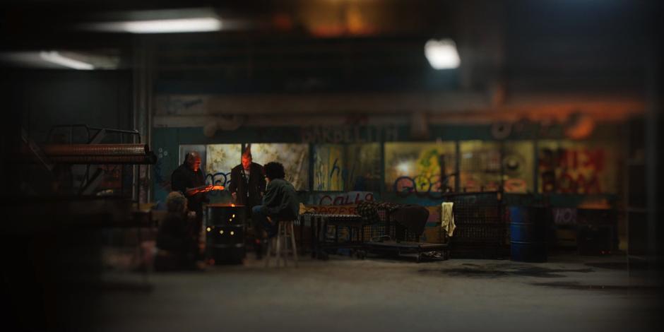 Eleven has a vision of a group of folks huddling around an oil drum fire in a warehouse.