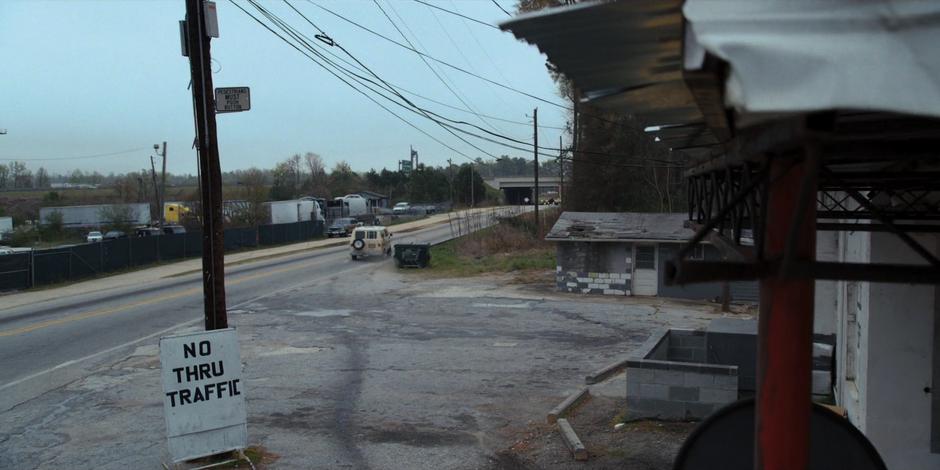 The van pulls out of the station and heads towards the highway.