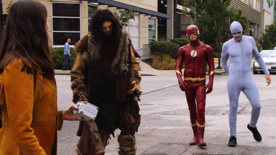 Barry and Ralph approach Mina Chayton after she gets the necklace from the armored truck using an ancient man statue.