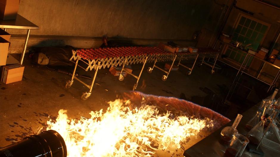 The fire lit by Ricardo Diaz spread across the ground of the lab.