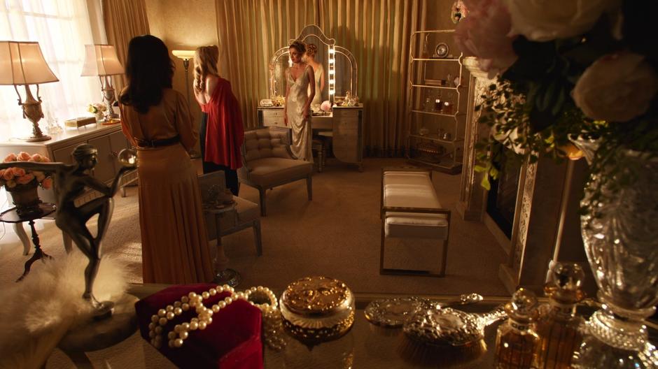 Zari and Sara approach Helen inside the mansion.