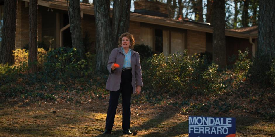 Claudia Henderson stands on the lawn trying to attract the missing cat,