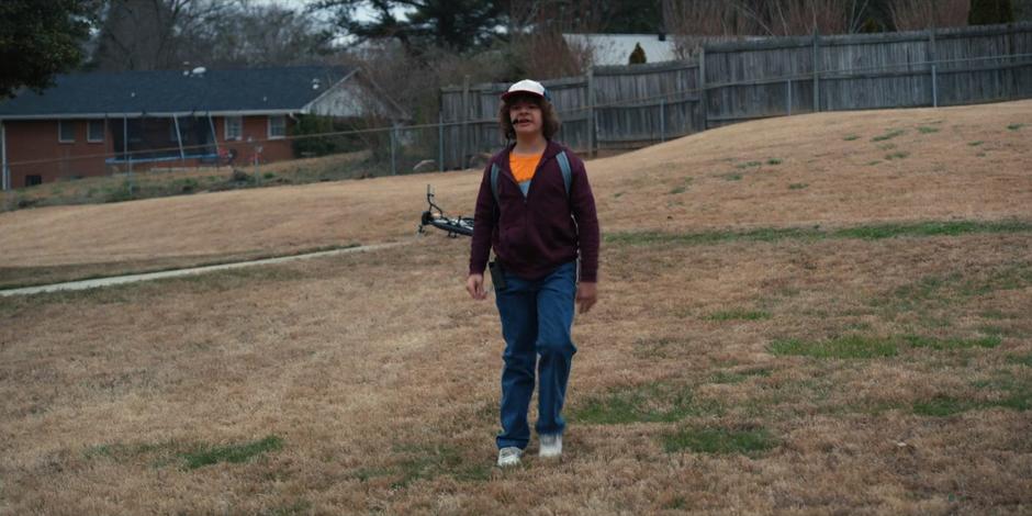 Dustin sees Steve running up to the house with flowers.