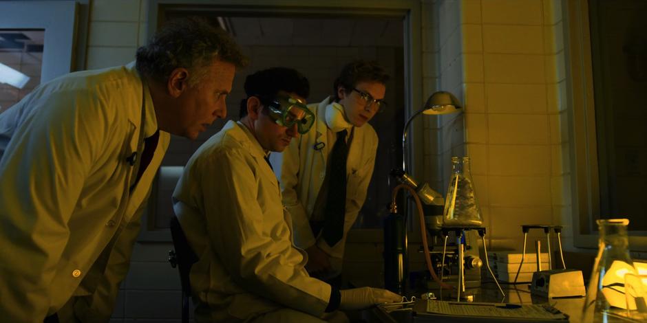 Dr. Owens watches as two lab techs demonstrate the strange properties of the collected soil.