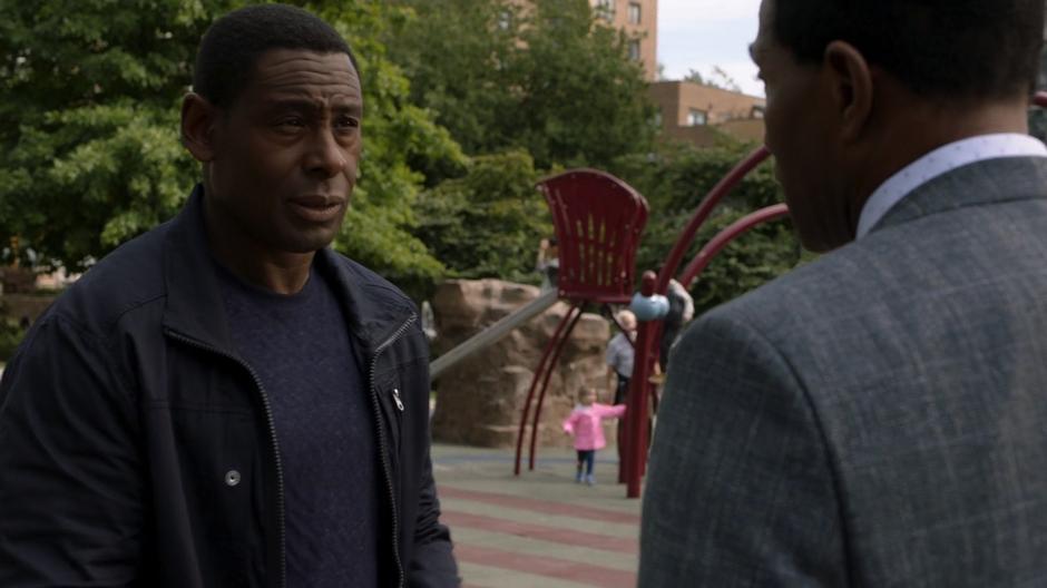 J'onn talks to his father in the park.