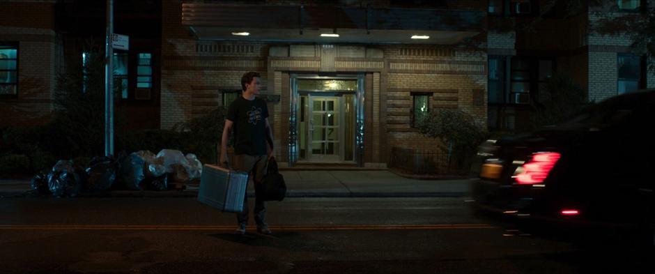 Peter stands on the street as Happy and Tony drive away.