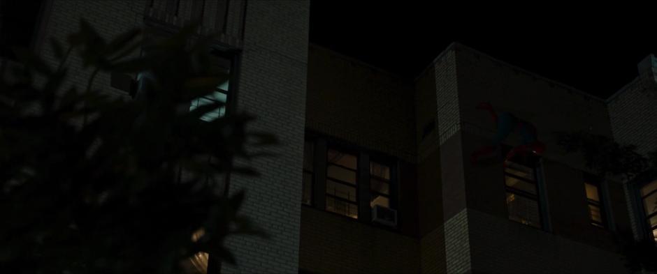 Peter scales along the outside of his building and slides the window of his room open.