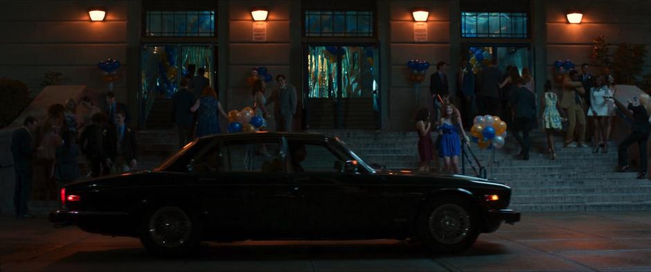 Adrian Toomes pulls up in front of the school for the dance with Peter and Liz.