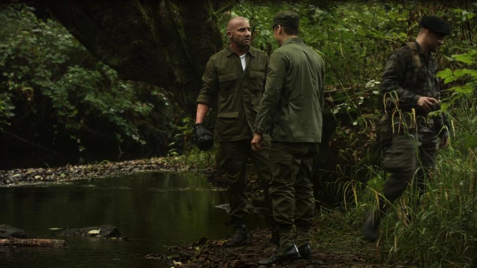 Mick and Nate talk by a stream after talking with Dick Rory.