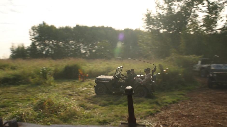 The president rides at the front of his convoy heading to the base.