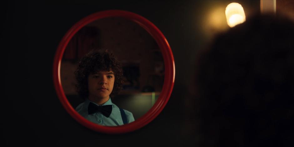 Dustin looks at himself in the mirror.