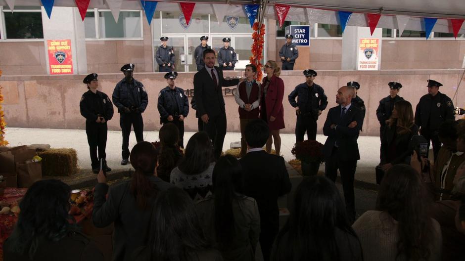 Oliver addresses the crowd with William and Felicity.