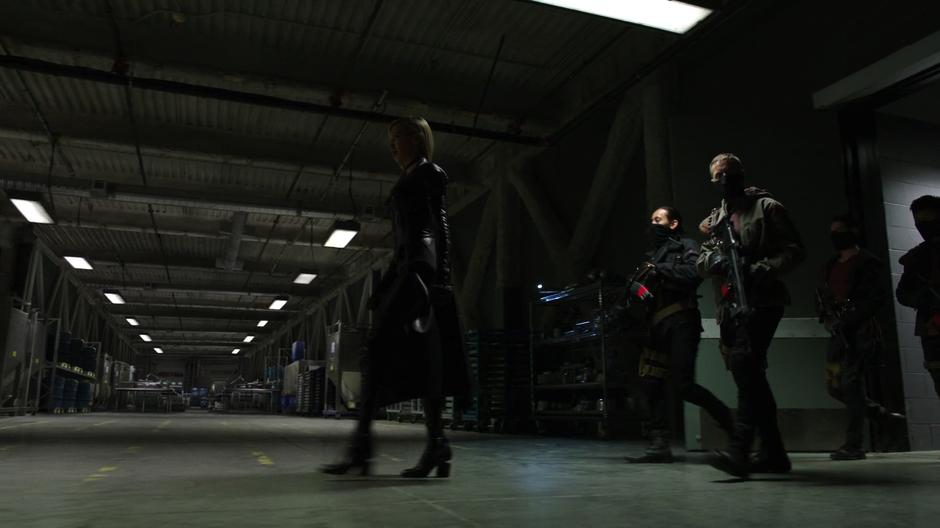 Black Siren enter the lab with her group of goons.