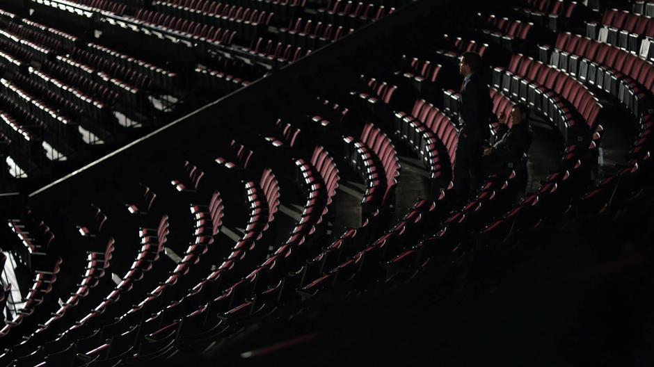 Oliver walks into the empty stadium to talk with the promoter about canceling the event.