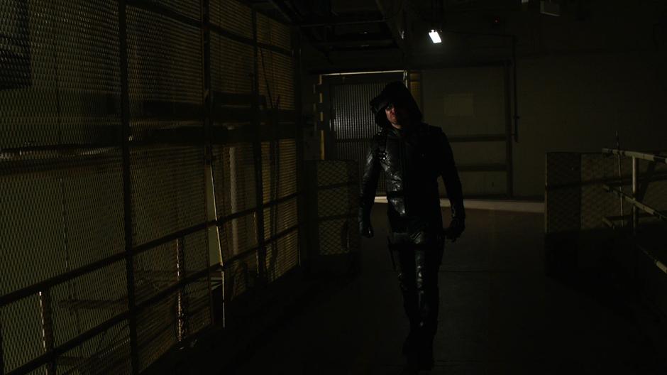 Oliver walks through the building looking for the Earth-X people.