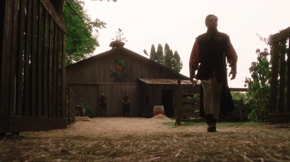 Guards stand outside the barn where Todd and Amanda are locked up.