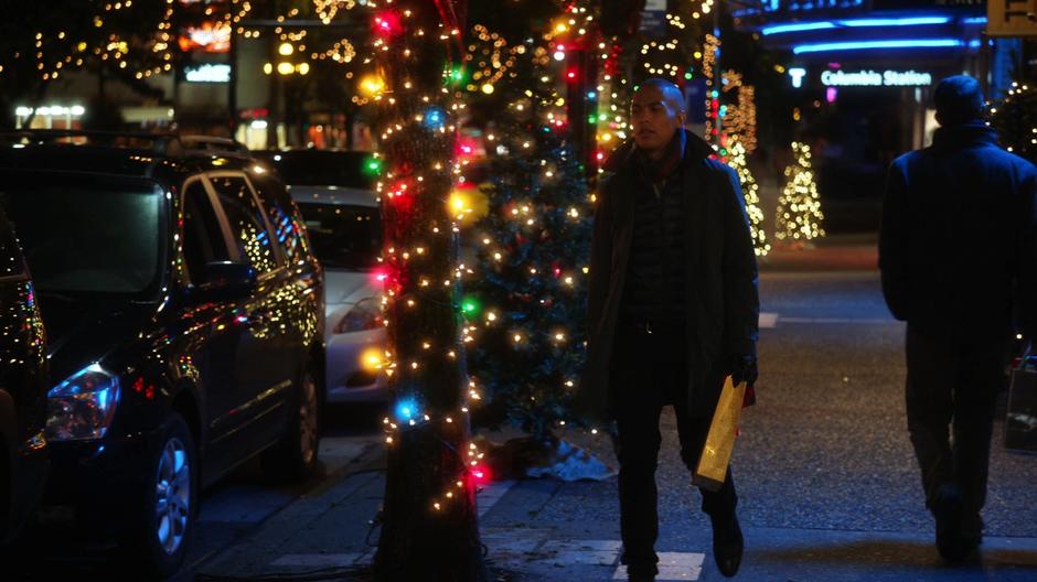 Dominic walks down the street back to his car.