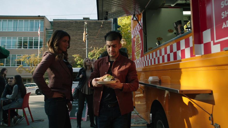 Dinah and Curtis follow Rene over to a table after he gets his burger.