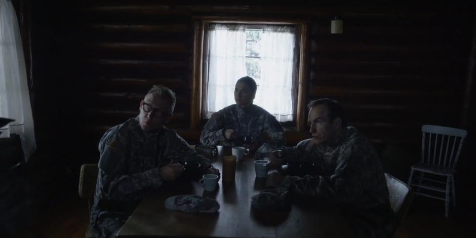 The three Faction members eating inside look up at the two guards who came inside.