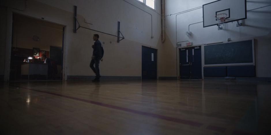 Trevor walks up to Coach Perry's office in the gym.