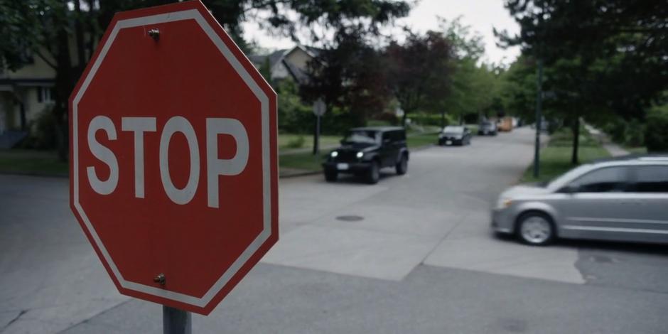 Kyle drives through a stop sign as another car slams on its brakes.