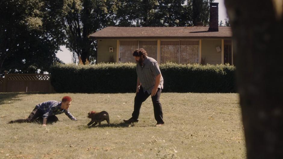 Scott and Bob play with their new dog.