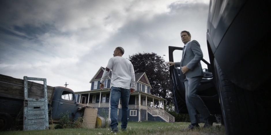 Grant and Luca get out of the car at the house.