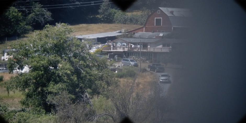 The Faction agents drive down the road near the house.