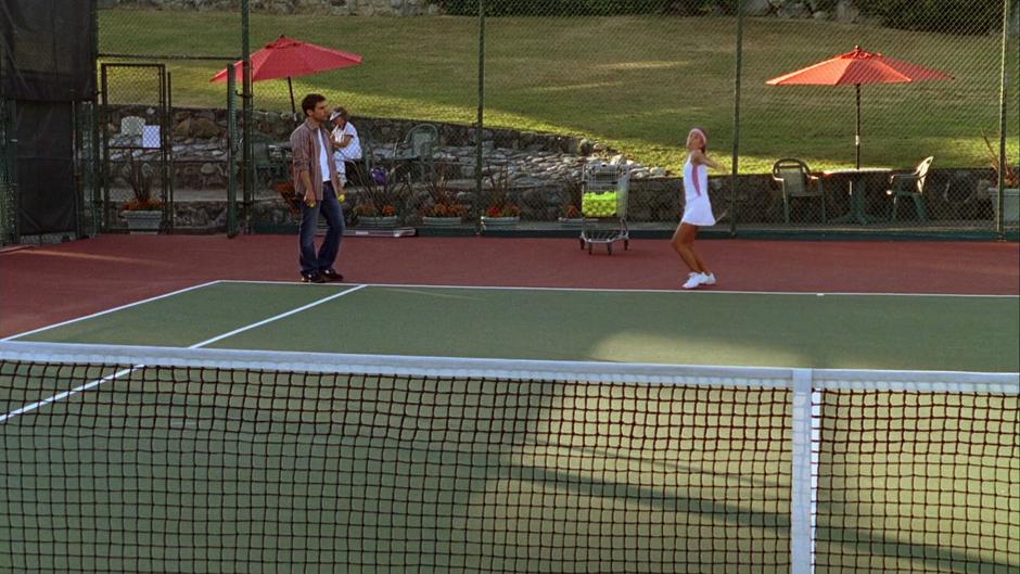 Shawn stands by while the girl makes a serve at Gus.