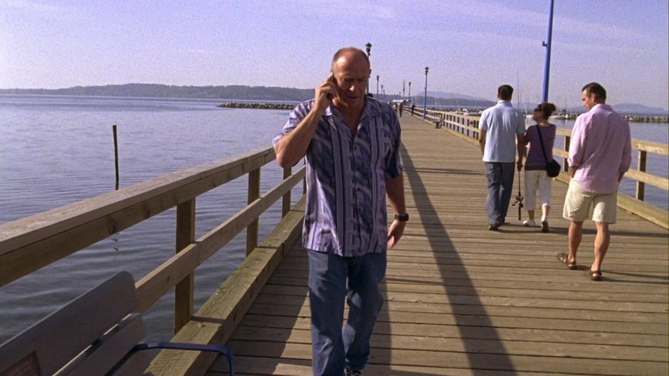 Henry calls Shawn on the phone from the pier.