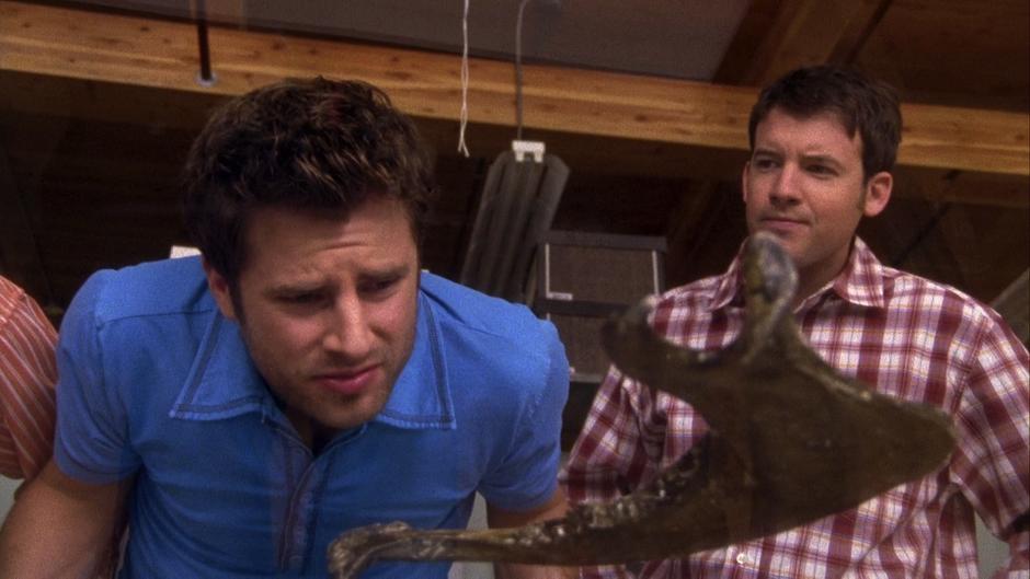 Shawn examines the department's collection of fossils while the grad student explains their collection.