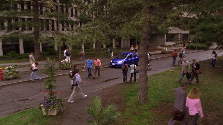 Shawn and Gus walk down the street after parking the Blueberry.