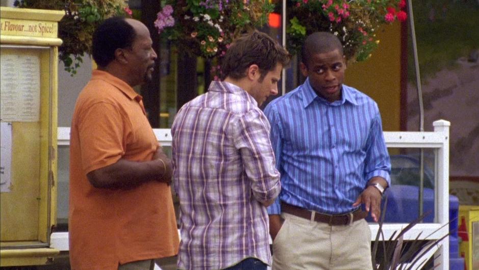 Gus talks to Uncle Burton and Shawn outside the restaurant.