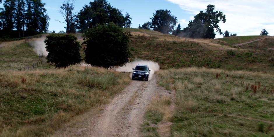 Grant drives his SUV down the dirt road after his meeting with Vincent.