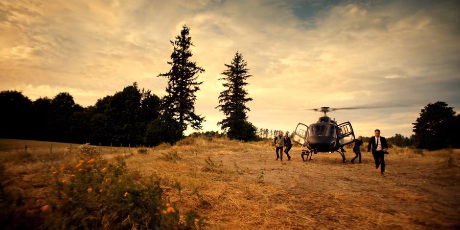 Philip, Carly, Marcy, and Grant jump out of the helicopter.