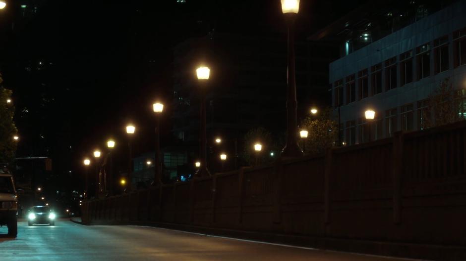 The pursuing driver heads down the empty street.