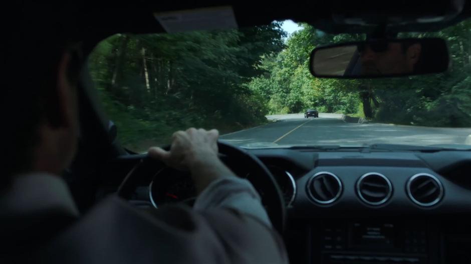 Mulder follows the other car through the woods.