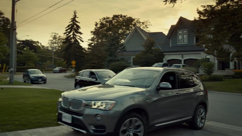 Mary drives her car into the driveway.