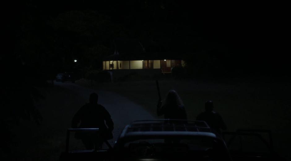 Three mercenaries get out of their car outside the house.