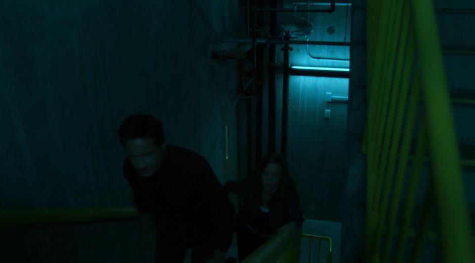 Mulder and Scully struggle up the stairs near the 25th floor.