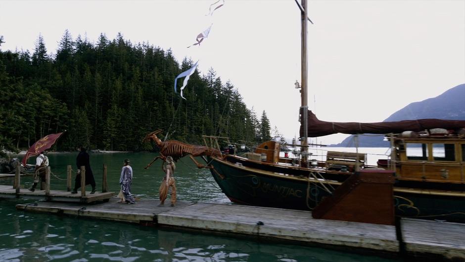 Tick Pickwick, Eliot, Fen, and Fray walk down the dock to shore.