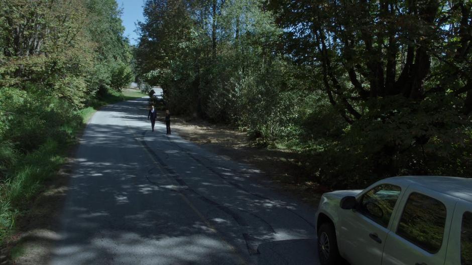 Mulder and Scully examine the skid lines leading to the crash.