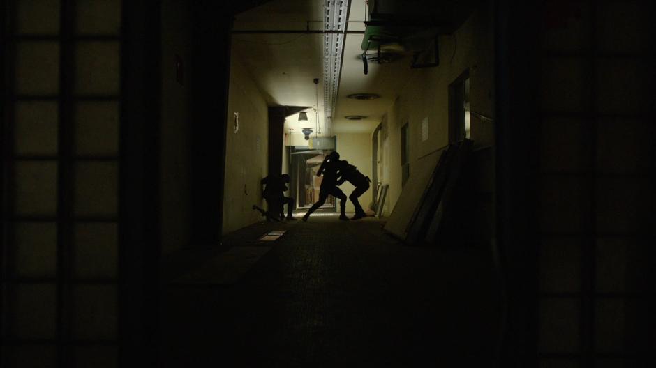 Oliver fights with several of Cayden James's goons in the hallway.