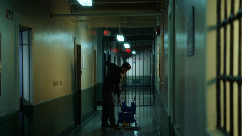 Barry mops the floor in the hallway.