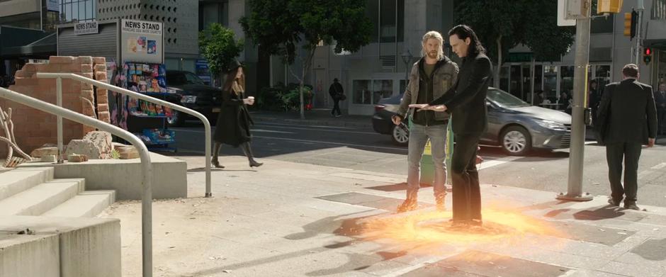 Thor watches as a strange portal appears under Loki's feet.