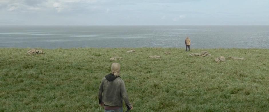 Loki sees Odin standing at the edge of the cliff overlooking the ocean.