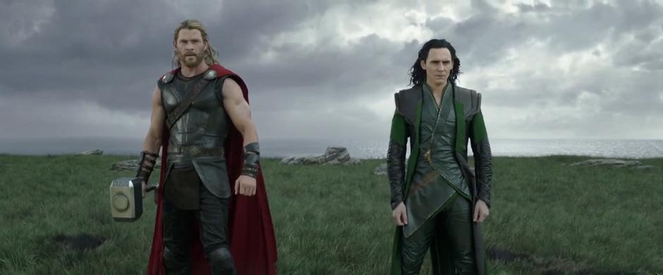 Thor and Loki stand facing their sister after changing into their fancy outfits.