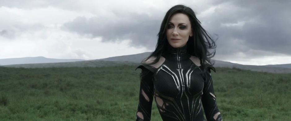 Hela appears in the field before her brothers.