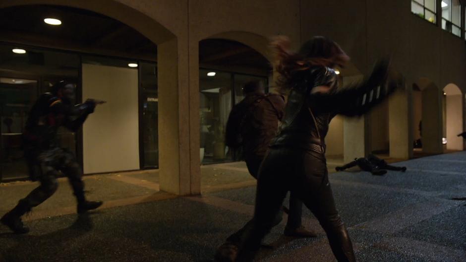 Dinah fights one of the goons while Rene runs past shooting.